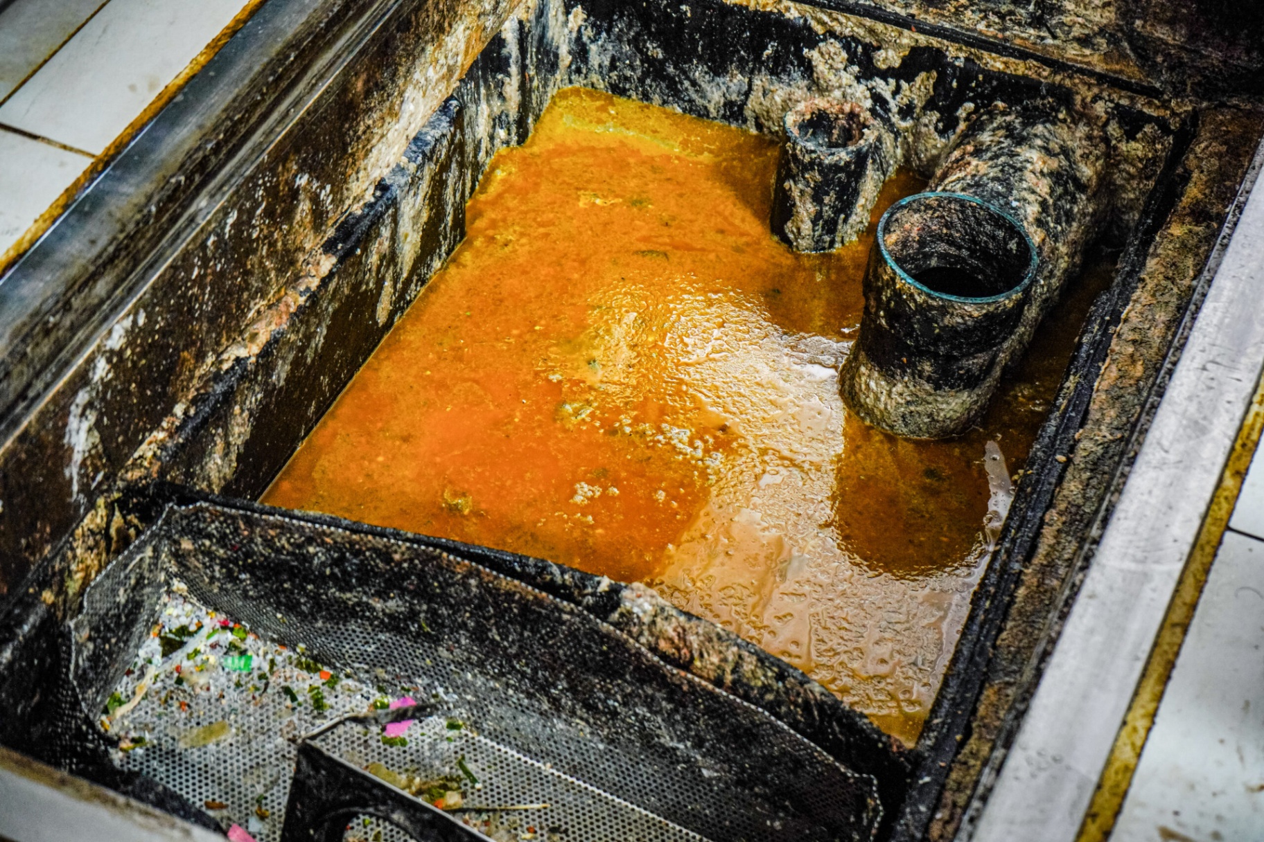 Dirty grease trap with heavy buildup